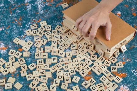 Designed by Freepik wooden letters spilled on a blue table